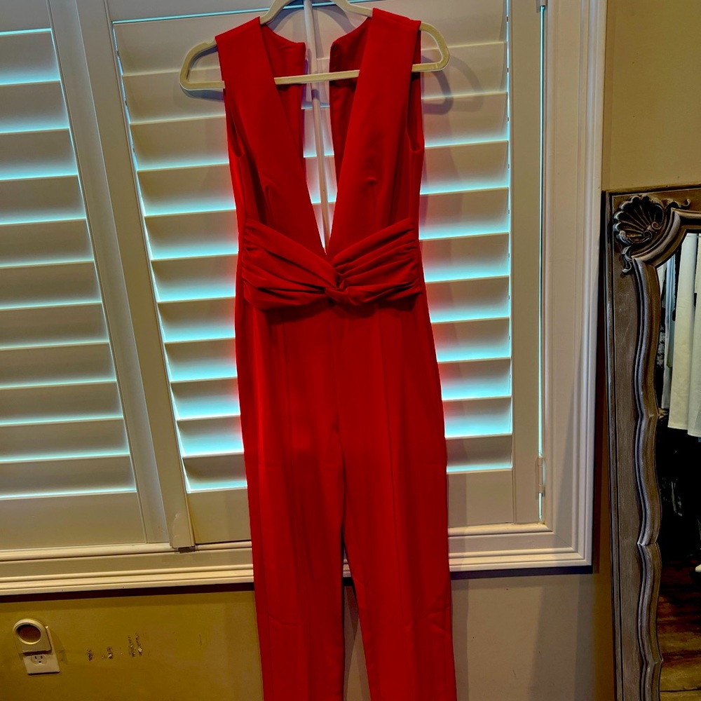 Classy yet sexy. Never worn red low cut jumpsuit.